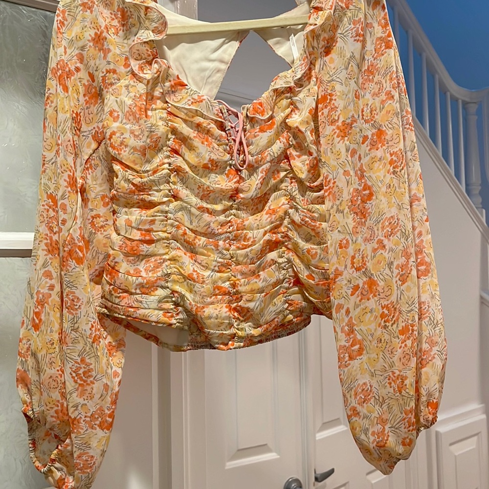 Free people long bell sleeve floral top with cut out back
